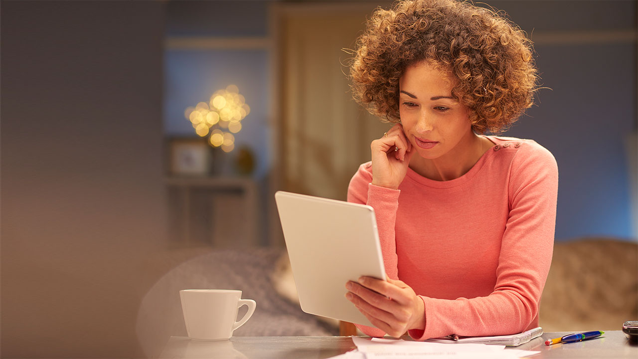 Woman sitting with her Tablet; image used for HSBC LK estatements page.